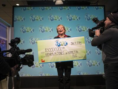 Lotto Max Winner Kathryn Jones Holding Oversized Cheque