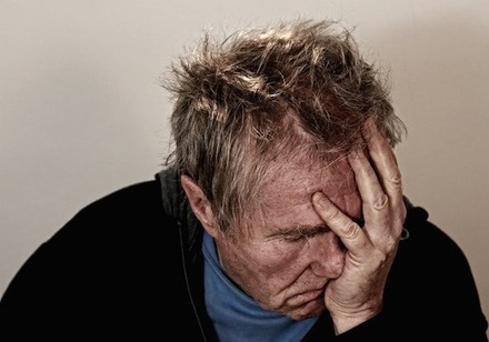 Disheveled Man Crying into Hand