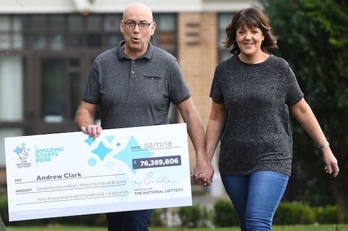 EuroMillions Winner Andrew Clark with Oversized Cheque and Girlfriend Trisha Fairhurst