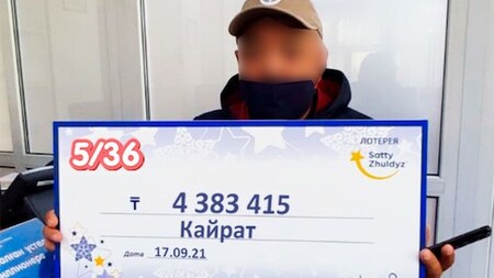 Kazakhstan Loto 536 Winner Holding Large Cheque