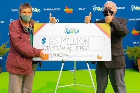 Lotto Max Winner James Wickman with Wife and Oversized Cheque