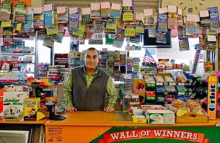 Lotto Retailer Standing at Checkout Counter