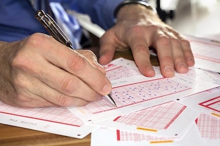 Man Filling Out Lottery Play Slip