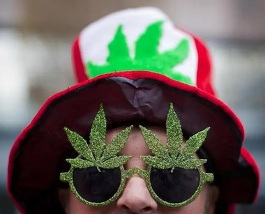 Man in Marijuana-Themed Hat and Glasses