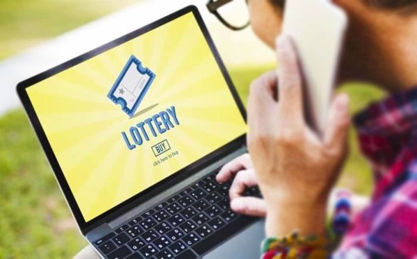 Man Playing the Lottery Online on Laptop