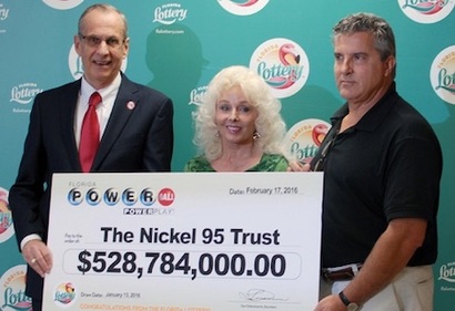 Maureen Smith and David Kaltschmidt Holding Oversized Check