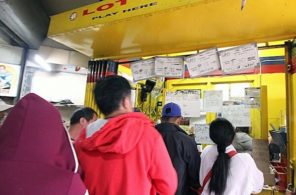 People Lining Up to Buy Philippines Grand Lotto Tickets