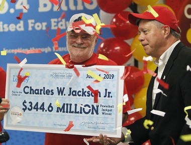 Powerball Winner Charles W. Jackson Jr. Holding Oversized Cheque